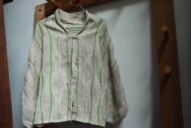 loosely structured shirt on a hanger, with characteristic ondule cells of closer and looser density.