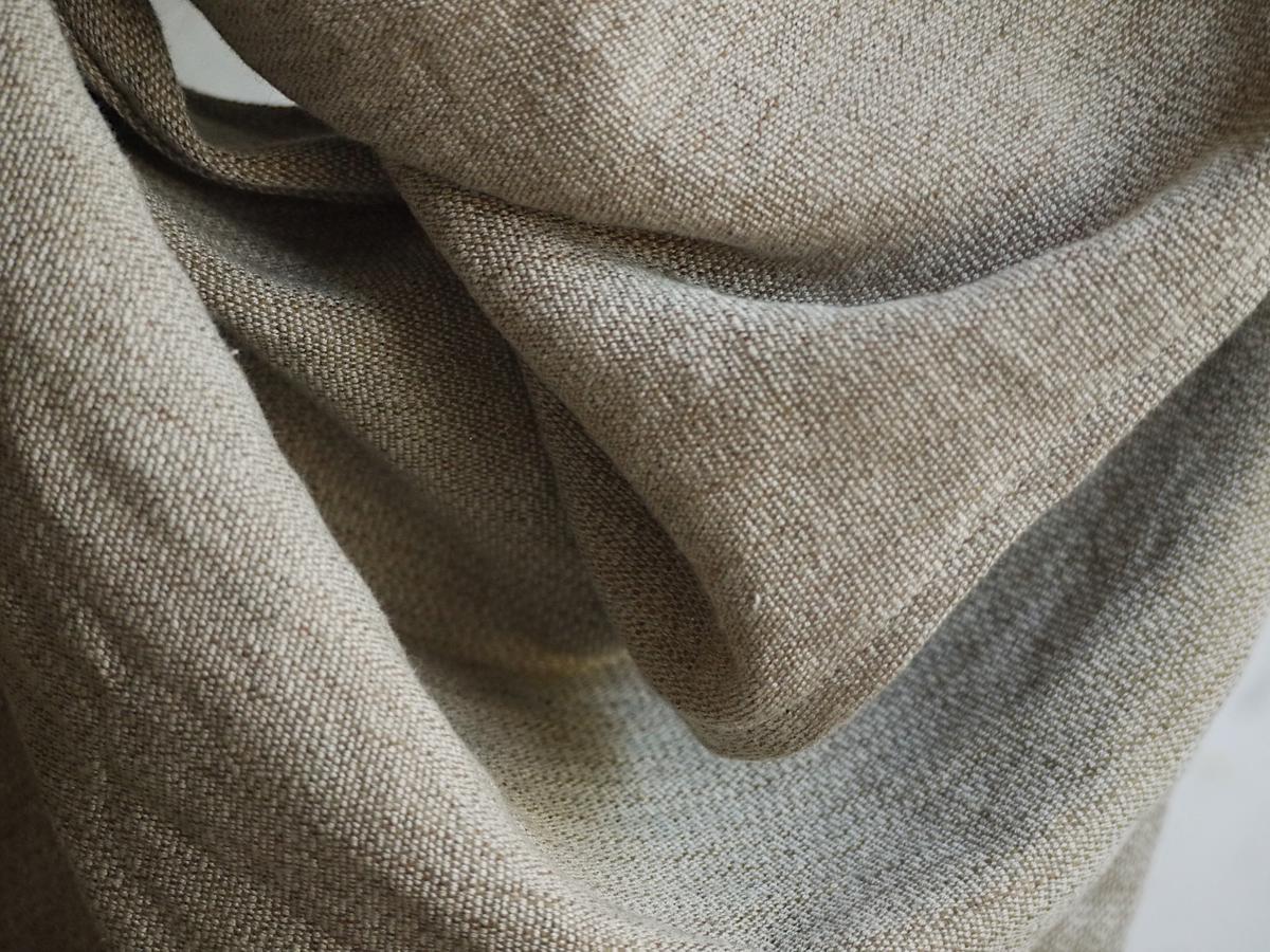 a close-up of the canvas, with shiny unbleached linen warp and brown, soft yak wool weft.