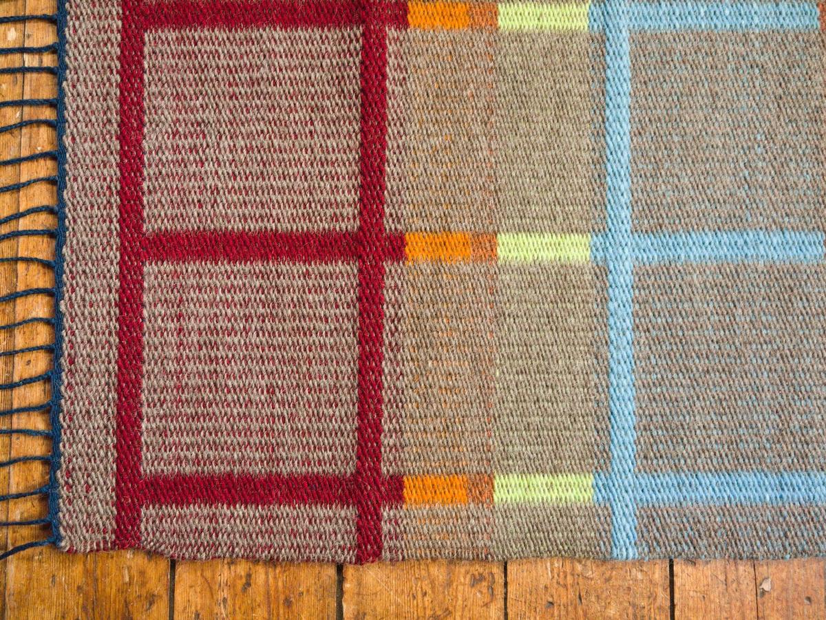 close-up of the rug's corner on a wood floor.